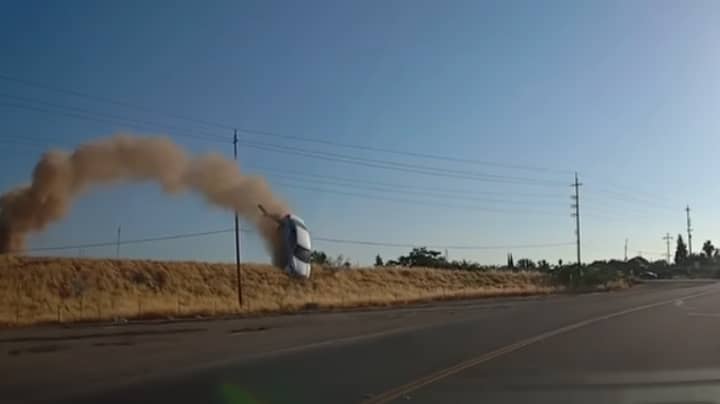 Driver Watches In Horror As Smoking Car ‘Flies Through Sky’ Onto Road