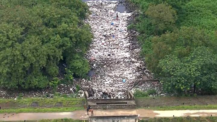Man Walks On River Due To Amount Of Rubbish Accumulated